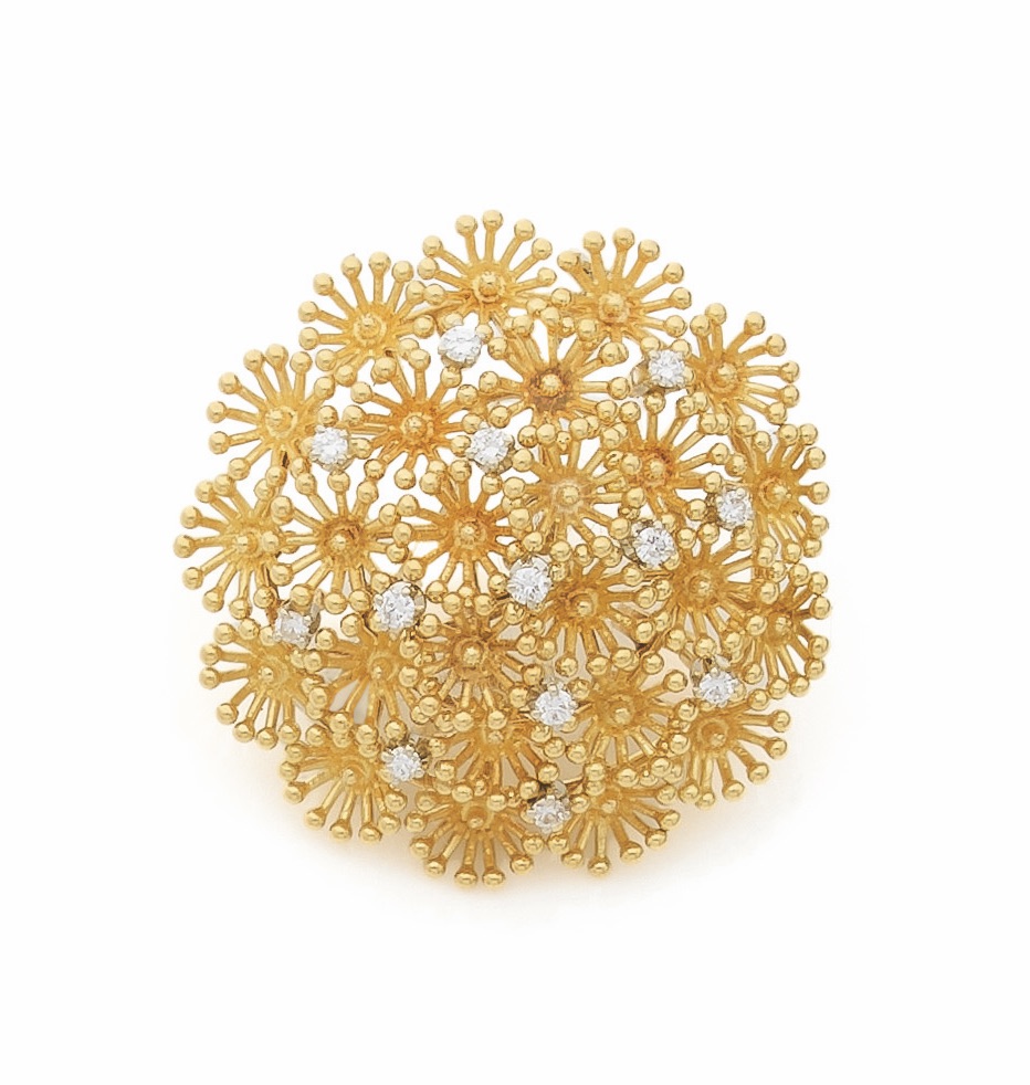 Broche-pendentif en or 18K (750) dessinant une anémone de mer piquée de diamants ronds 
